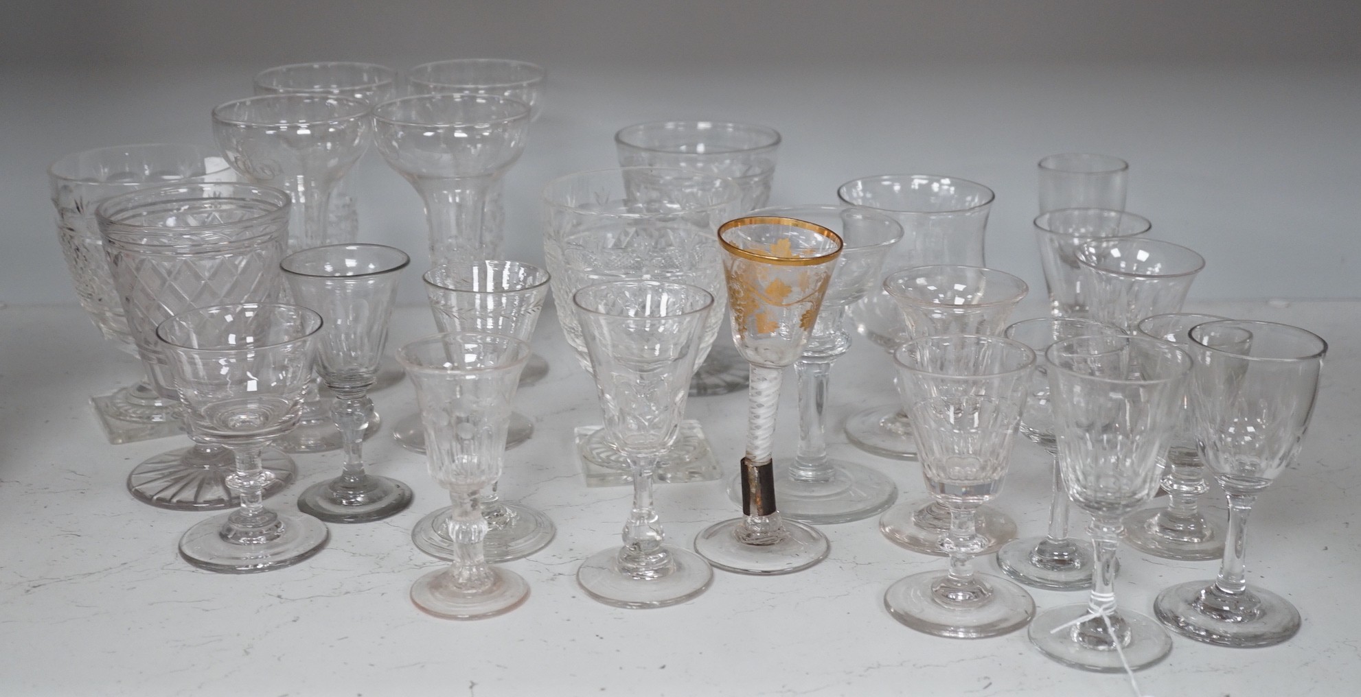 A quantity of assorted 18th / 19th century and later clear drinking glasses including a damaged James Giles gilt decorated opaque twist stem wine glass.